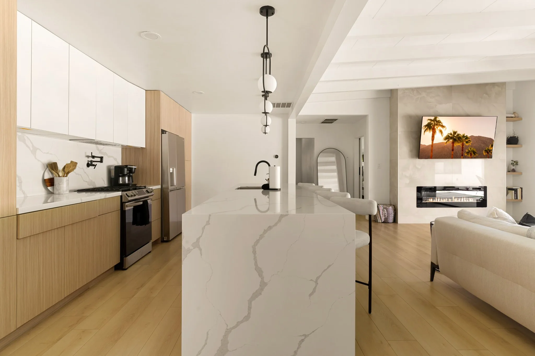 Kitchen island in white marble under exposed beams, The Villa Palms, Indio, California